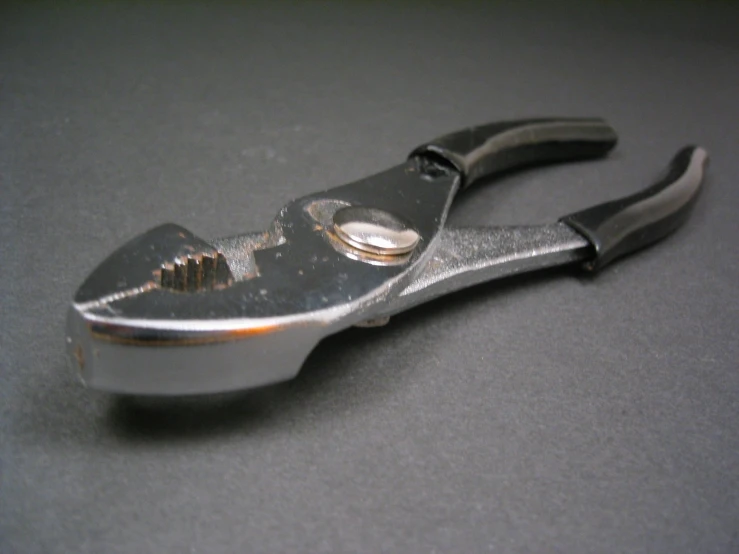 a close up of a pair of scissors with a screwdriver on top of it