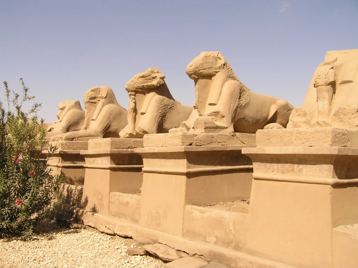 a stone wall that is covered with sphinx sculptures