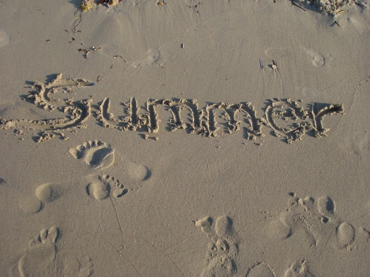 a sand word written on the beach in the middle of winter