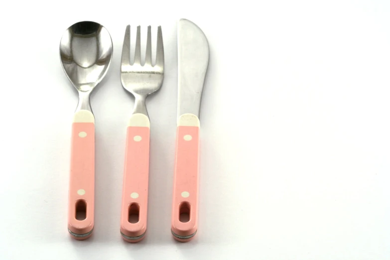 there is a set of kitchen utensils with a light pink handle