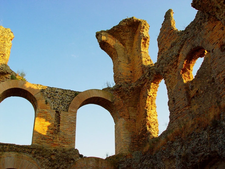 a bird flying in the air over a ruin