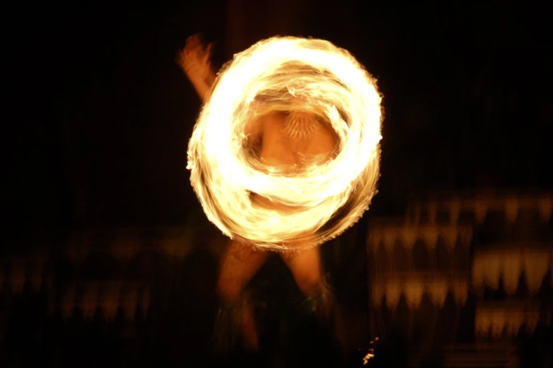 a man is spinning a large circle on his hand