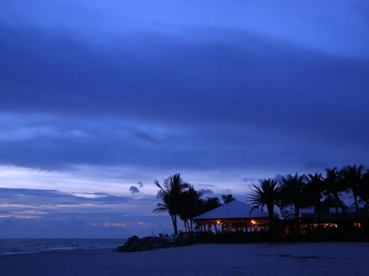 a large building sitting on the side of a beach