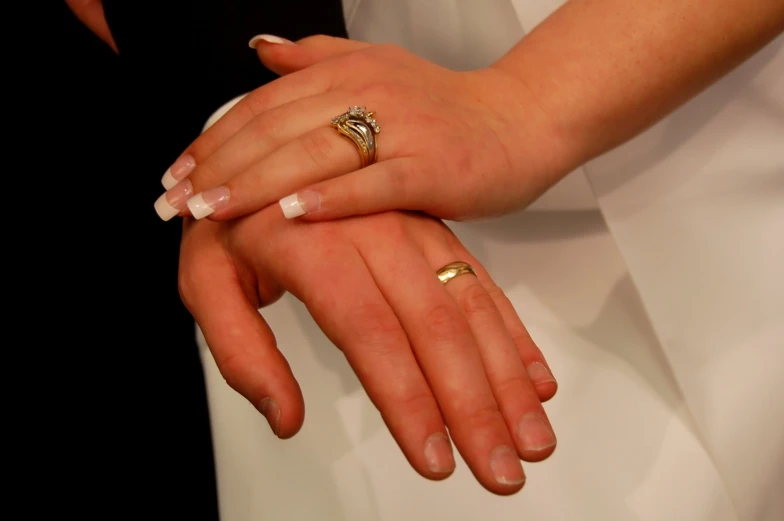 a bride and groom with their wedding rings