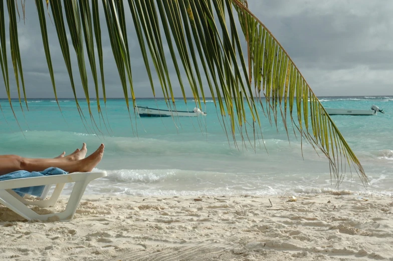 a man laying in a beach chair on a sunny day