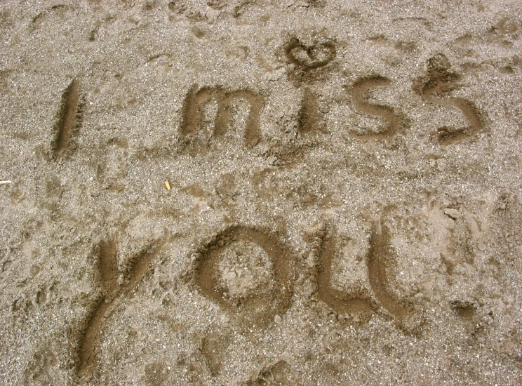 words and letters drawn in the sand on the beach