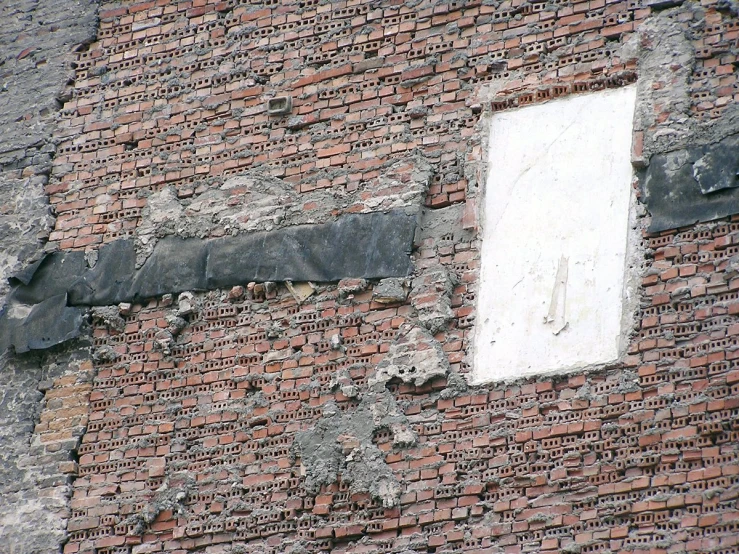 this old brick building with several holes in it