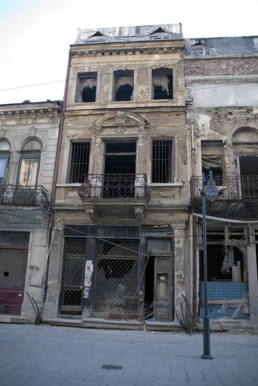 old buildings and a light post sit empty on a street corner