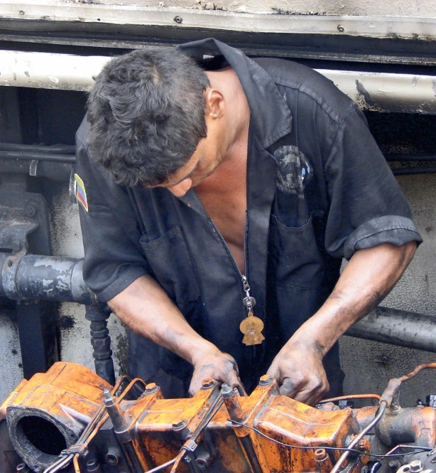 a man  out metal parts at an open machine