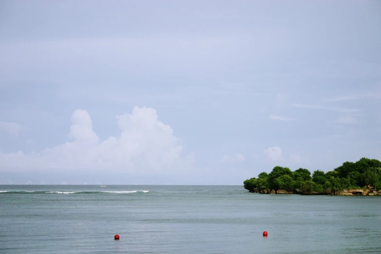 a small island in the middle of some blue water