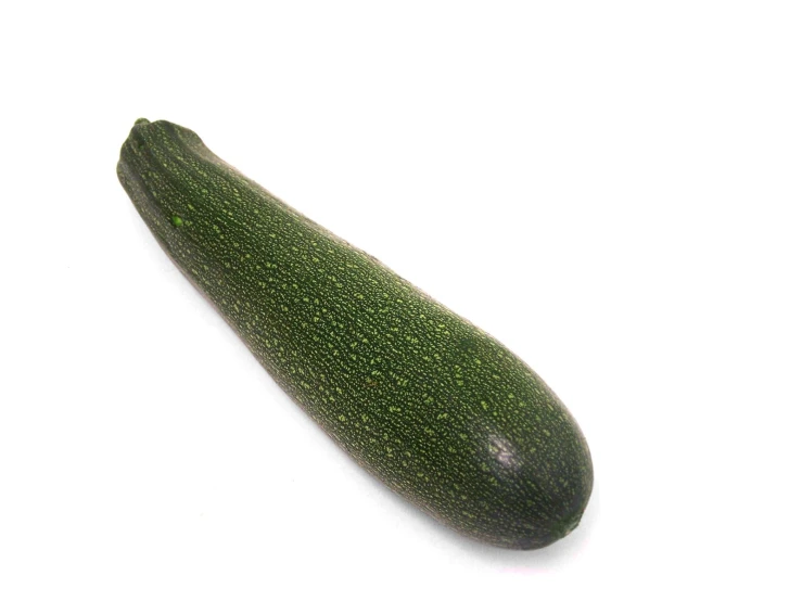 an oval shaped, green zucchini against a white background