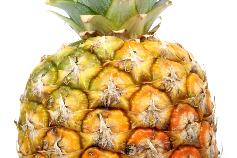 a pineapple with several fruit types on top
