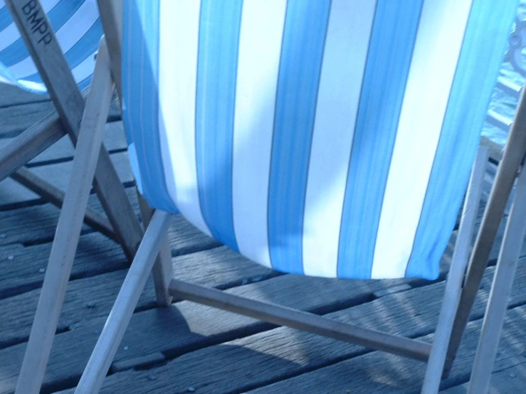 two empty lawn chairs are facing each other