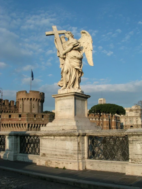 there is a statue of a woman that has a cross on top of it