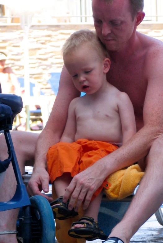 a man and a small child on top of a swim chair