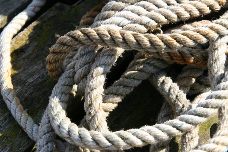 a closeup of some rope knot on a wooden surface