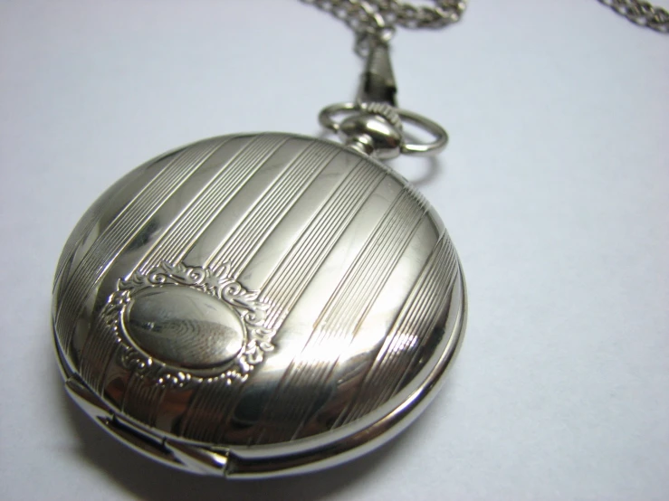 a pocket watch with an empty chain on the table