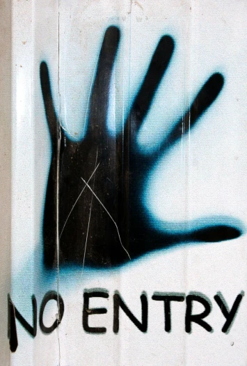 a sign with the hand and no entry painted on it