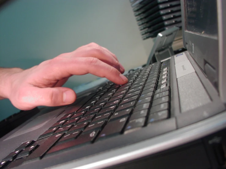 hands that are touching a keyboard on a laptop