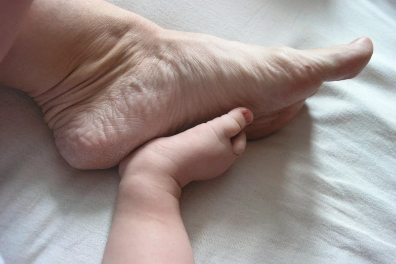 an unborn baby foot laying in a bed