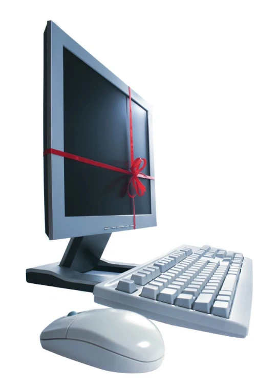 a computer keyboard and monitor wrapped with a red ribbon