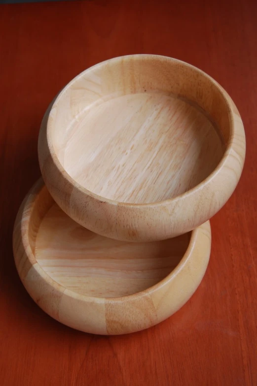 a couple of wooden bowls sitting on top of a table