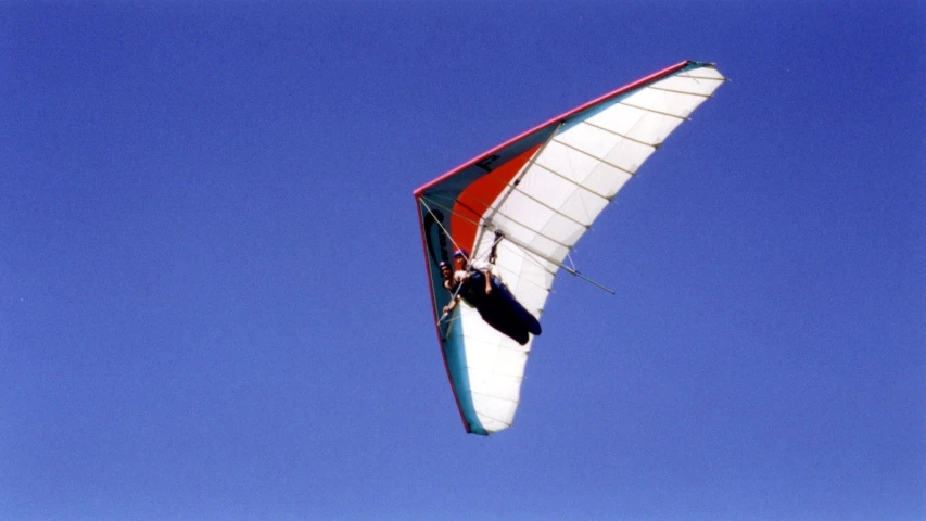 a red, white and blue sail with a person on it