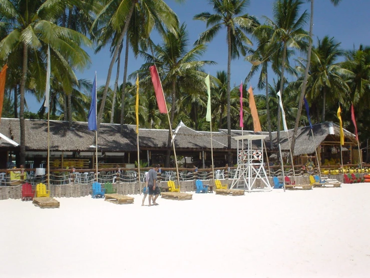 a white beach filled with colorful chairs and umbrellas