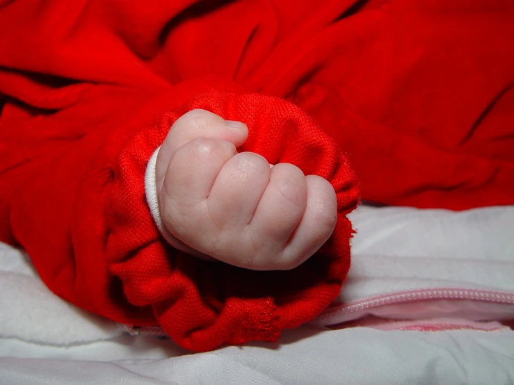 a newborn baby is seen being held in an upside down position