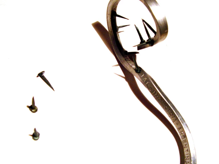 a close up of a clock with scissors in front