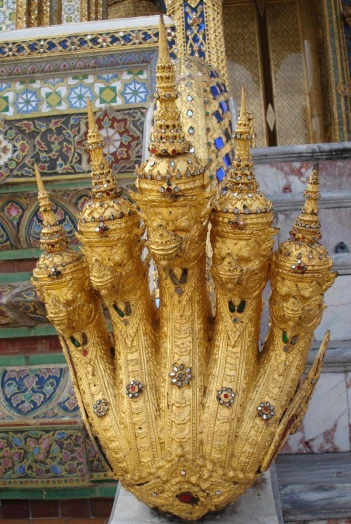 a gold statue made to look like many pagodas