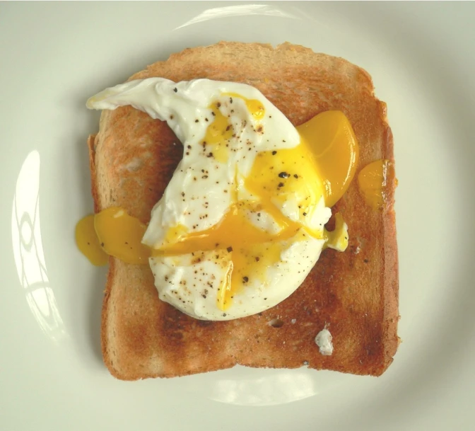 the breakfast toast on the plate has been done with some toppings