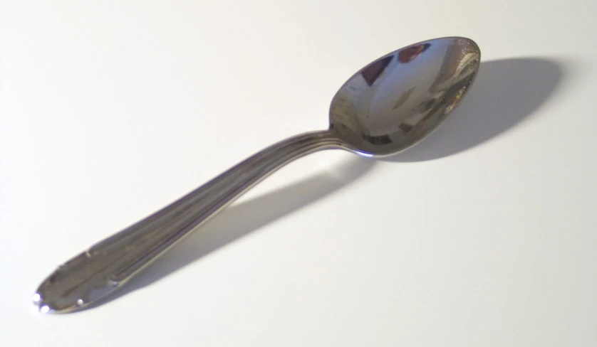 a spoon with a piece of silver on the top