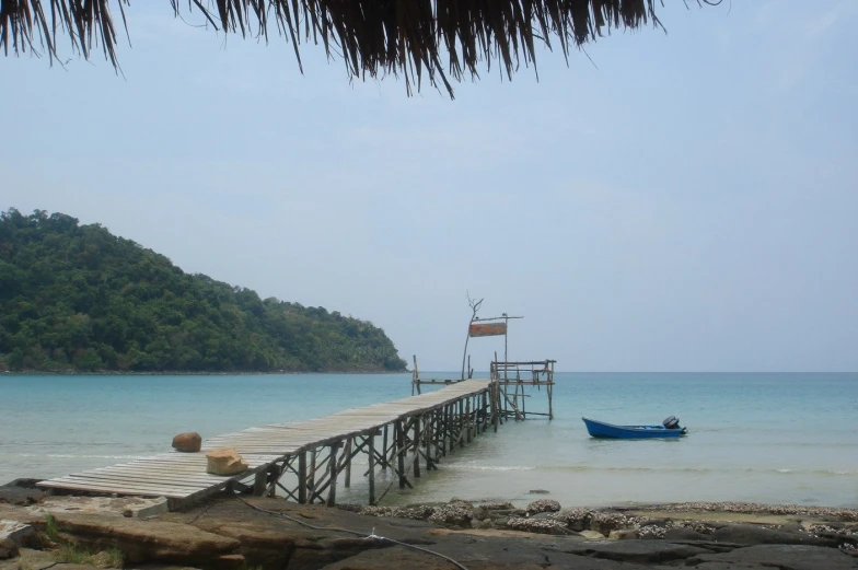 the boat is docked near a wooden pier