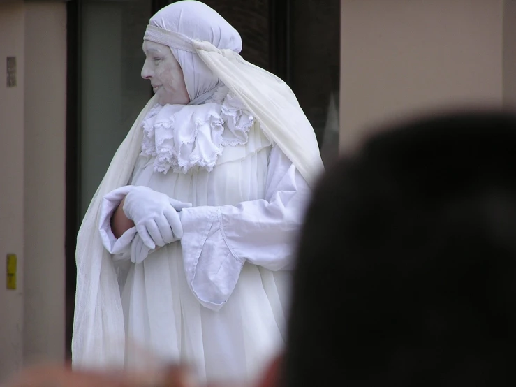 a statue has white clothes and long white hair