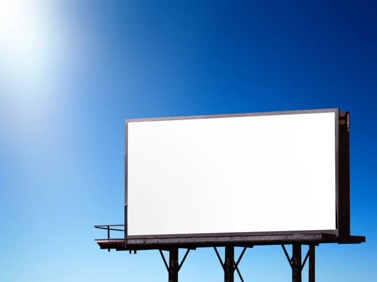 an empty billboard is shown on a sunny day