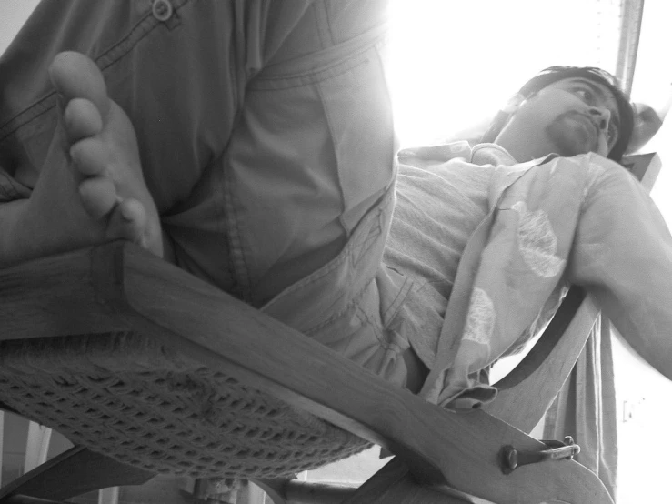 a person with an arm extended sitting in a chair