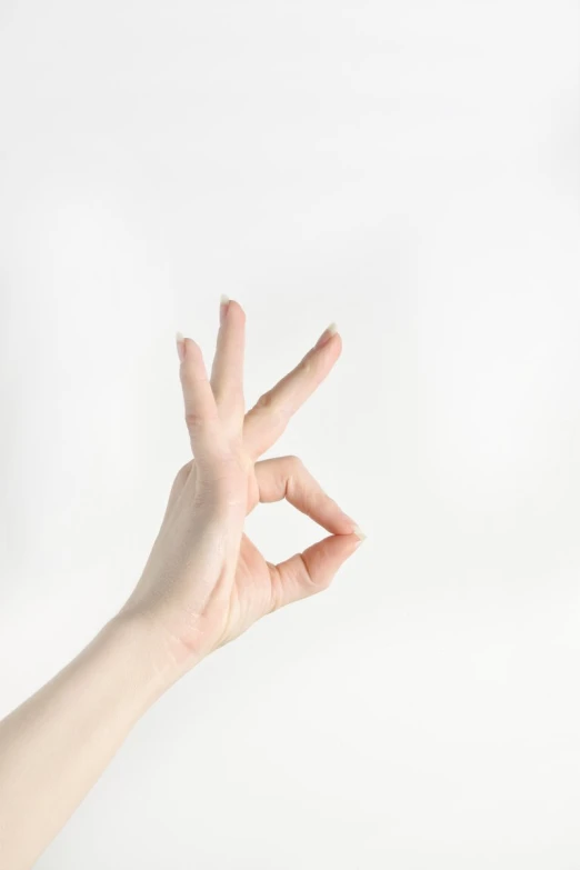 a hand holding up the middle finger of a peace sign