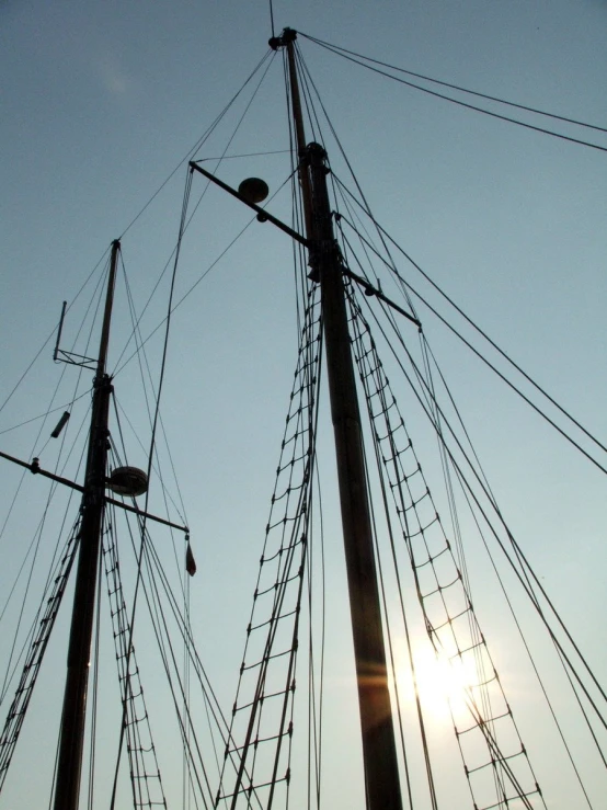 a very large ship sitting next to a tall pole