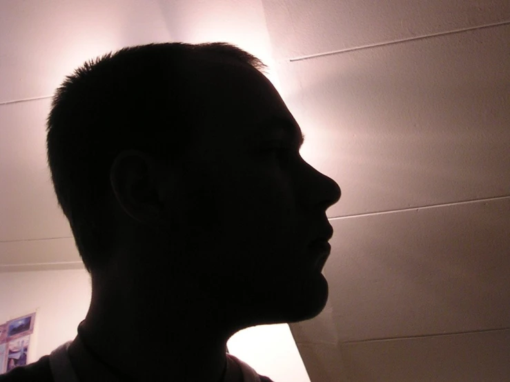 a man standing in front of a light up lamp