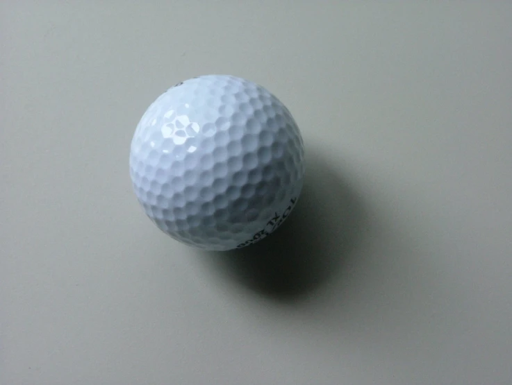 a white golf ball sitting on top of a table