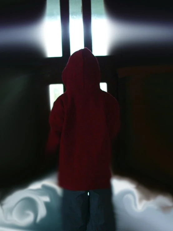 a person is dressed in red while standing near a bed