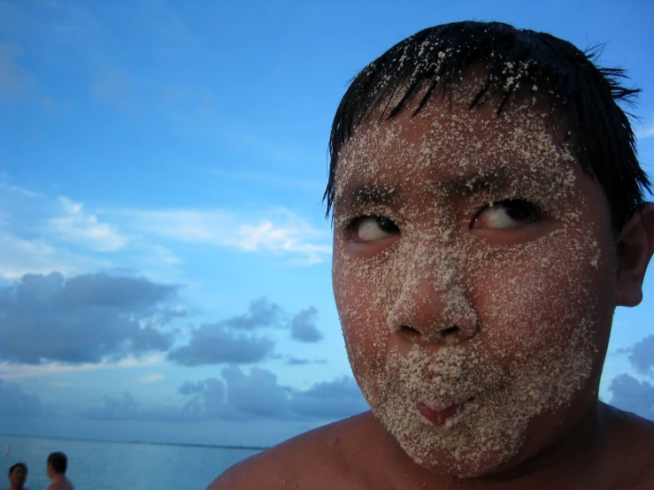 a man making a face with sand on his face