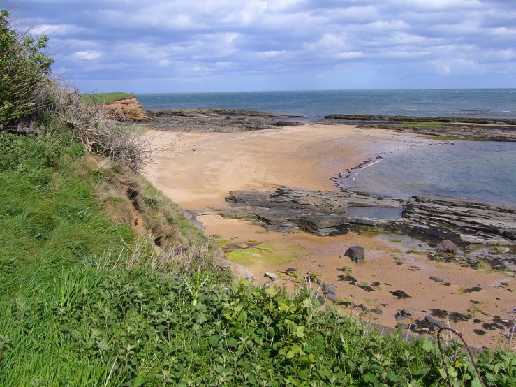 the shoreline of a beautiful sea shore area with lots of sand