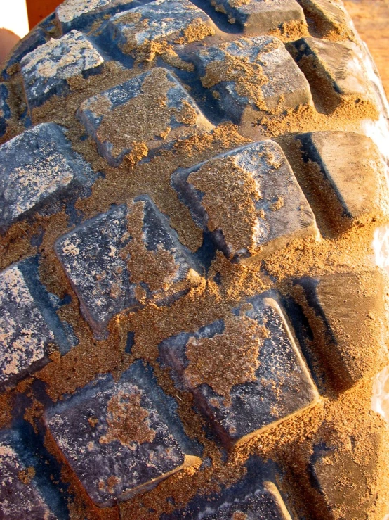 a worn tire tire is shown with patches of dirt