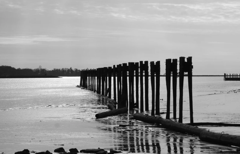 old water pipe near the beach under a cloudy sky