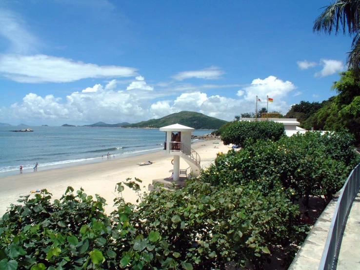 the beach is next to a walkway in a tropical setting