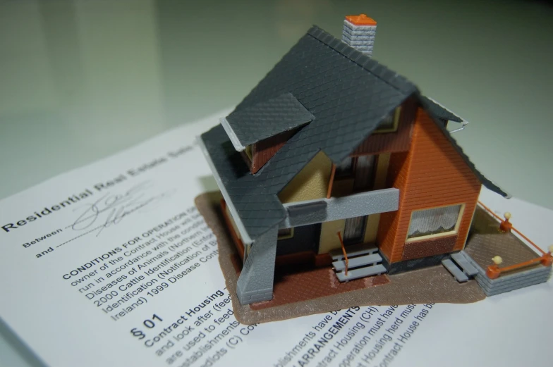 a house on top of some papers is in focus