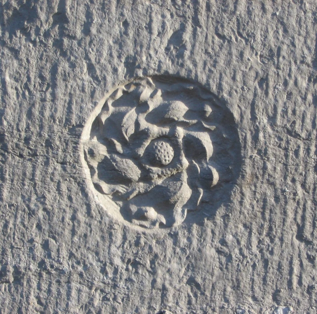 a white object carved into a sandy surface