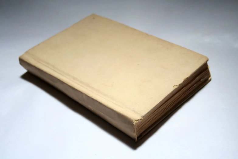 a close up of a book on a white table